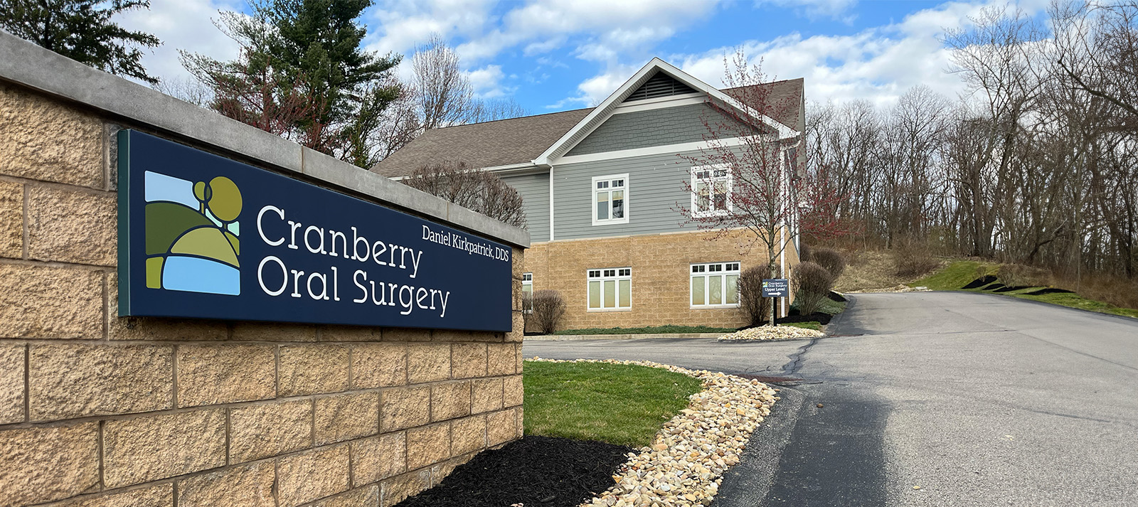 The image shows a sign for CRANBERRY ORAL SURGERY, indicating the location of the dental practice.