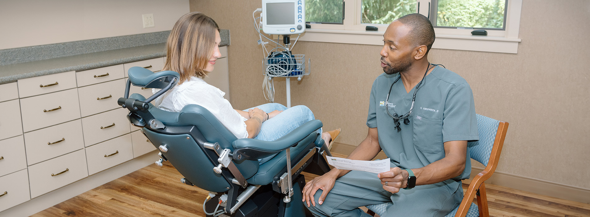 In the image, a man and woman are seated in a dental office setting.