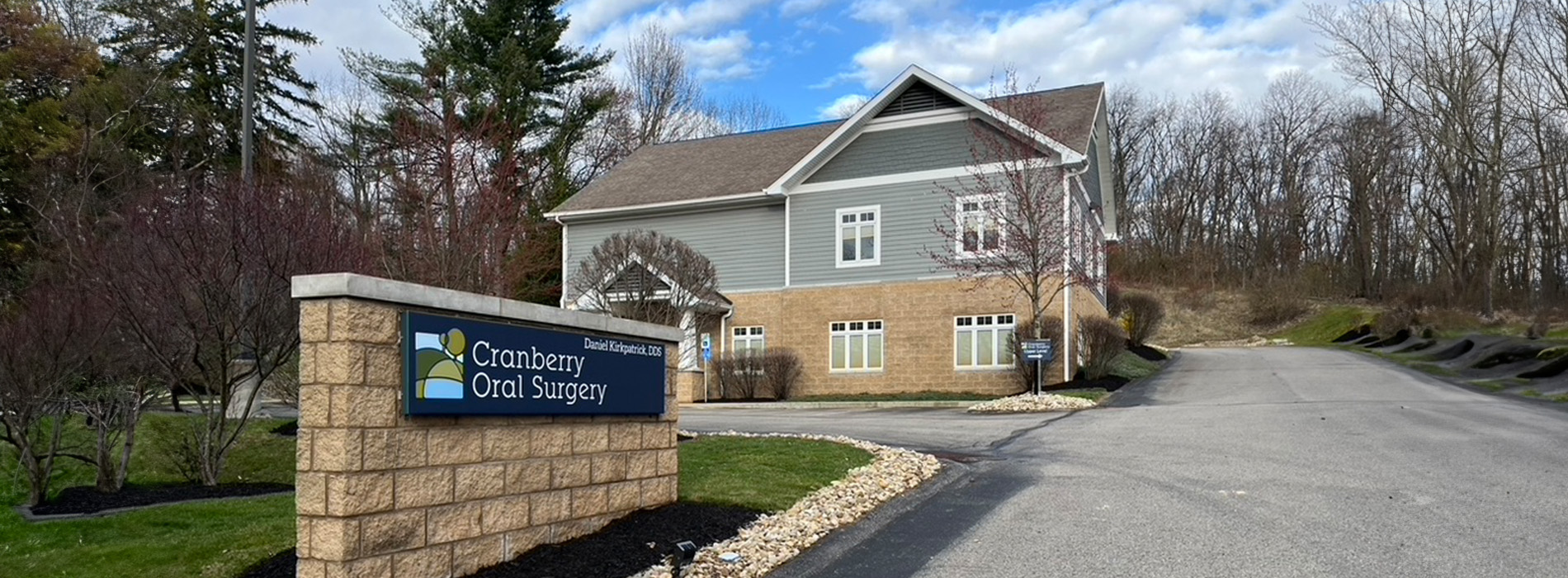 The image is a photograph of a brick building with a sign that reads  Cherry Hill School District  in front. The structure has a prominent entrance and appears to be an educational institution.